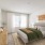 Furnished bedroom with large windows