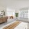 Large well lit bedroom with plush carpets and large windows 